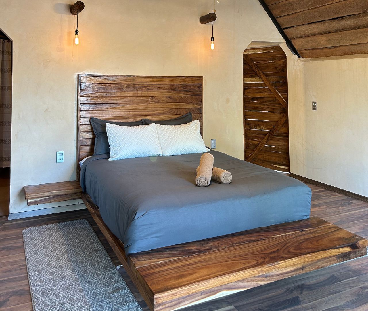 Cama Queen con cabecera de parota en la Suite Tuunich